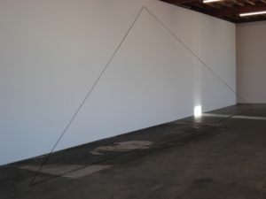 Fred Sandback Untitled (leaning triangle) 1990 acrylic black yarn. Dim variable. Image courtesy the Estate of the artist and Jensen Gallery